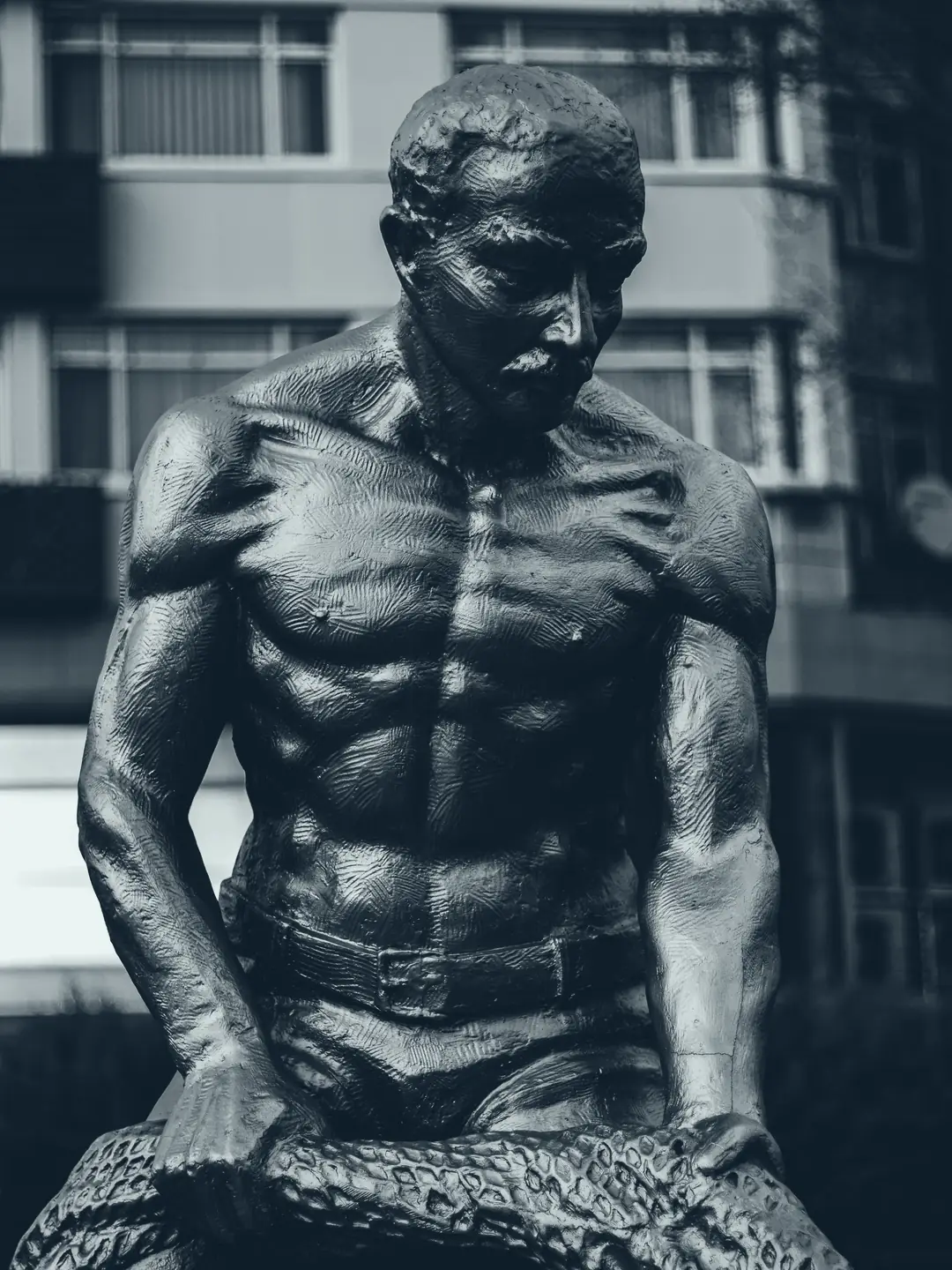 Bronze statue of a muscular figure